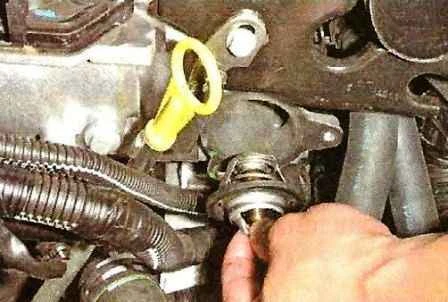 How to remove the thermostat and thermostat housing of a Nissan Almera car